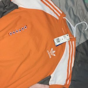 an bright orange adidas shirt 💕.